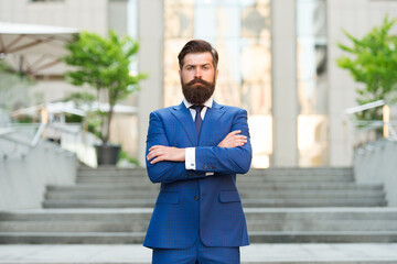 charmed life. Confident and handsome. serious bride groom crossed hands outdoor. brutal male beauty. formal and office fashion. man in suit wait at stairs. leadership concept. Businessman wear jacket