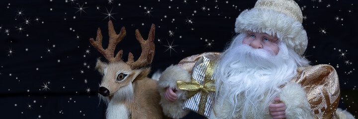 Santa Claus with a deer. Christmas toys on a black background