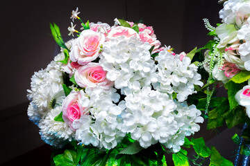 White and green color based artificial plastic flowers a bouquet. wedding decoration.