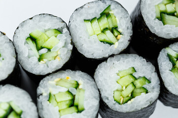 Japanese food. Rolls with ripe cucumber, fresh rice with vegetables in nori. Vegetarian rolls