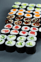 Japanese food. Rolls with ripe avocado, red fish, salmon, fresh rice with vegetables in nori. Set with rolls