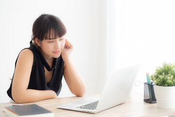 Beautiful freelance young asian woman thinking and idea working laptop computer at office, writer asia girl thoughtful inspiration writing blogging with notebook in job, business concept.