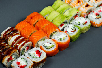 Sushi assorted. Sushi roll with avocado, cucumber. Sushi roll with salmon and caviar. Sushi roll with tuna and caviar. On a light background. Japanese food. View from above