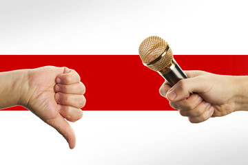 male person holding microphone at his fist over belarus flag background. hot news symbol. freedom of speech concept. dislike gesture