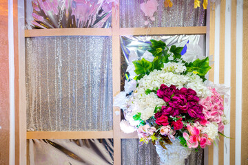 Fototapeta na wymiar Colorful artificial paper flowers vase based wedding stage decoration. Plastic artificial flower. wedding decoration.