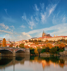 Obraz premium View on St. Vitus Cathedral and Prague Castle from across Vltava river on a bright Autumn day with reflection.