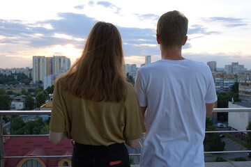 two teenagers on the roof of a building