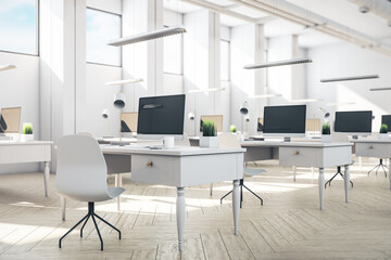 Minimalistic coworking office interior with computers with blank screen.