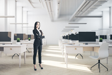 Businesswoman standing in coworking office