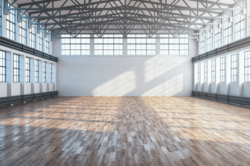Modern large hangar interior with brick wall and wooden floor.