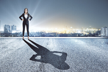Businesswoman stands on the roof of a skyscraper
