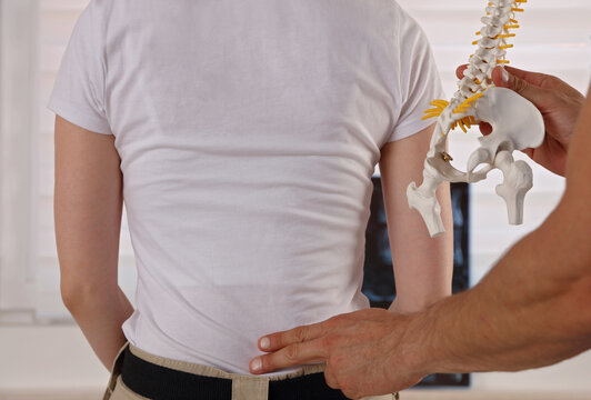 Low Back pain ,pinched nerve. Doctor Chiropractor explains causes of back pain to Patient