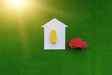 a man, a car made of wood, a house on a green background. Estate market. The property is owned.