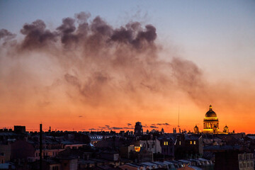 Fototapeta premium Sunset cityscape of Saint Petersburg with smoke after fireworks