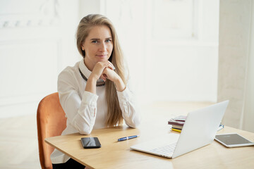 young businesswoman sitting at desk and working