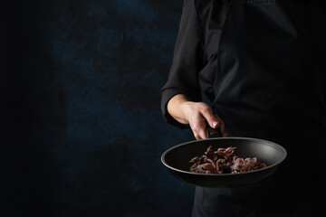 Chef's roasting octopus in a pan © Anton