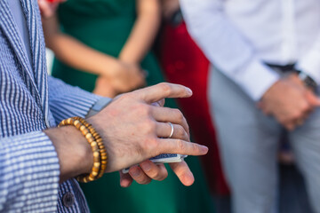 Fototapeta premium Magician showing card tricks focus in front of guests on party event wedding celebration, juggler performing show