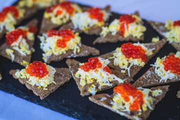 Beautifully decorated catering banquet table with different food snacks and appetizers on corporate christmas birthday party event or wedding celebration