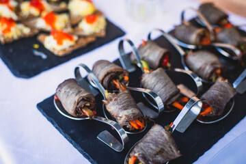 Beautifully decorated catering banquet table with different food snacks and appetizers on corporate christmas birthday party event or wedding celebration