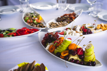 Beautifully decorated catering banquet table with different food snacks and appetizers on corporate christmas birthday party event or wedding celebration