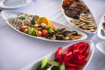 Beautifully decorated catering banquet table with different food snacks and appetizers on corporate christmas birthday party event or wedding celebration