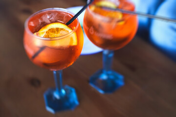 Row line of red colored negroni and spritz aperitif alcohol cocktails on a party of alcohol setting...