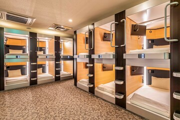 The two-story bedroom area is combined inside a modern capsule hotel in Japan
