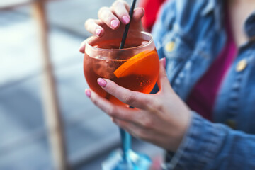 Row line of red colored negroni and spritz aperitif alcohol cocktails on a party of alcohol setting...