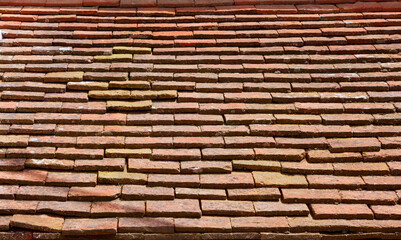 Old rectangular red ceramic tiles on the roof. Background image, texture