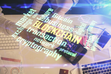 Double exposure of man and woman working together and crypto theme hologram drawing. Computer background. Blockchain concept. Top View.