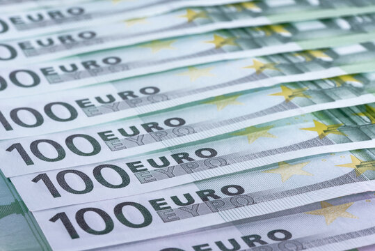 Heap of green houndred euro banknotes on each other