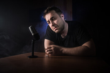 Serious reporter in television studio looking at the camera