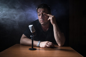 Serious reporter in television studio looking at the camera
