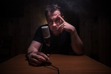 Serious reporter in television studio looking at the camera