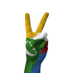 Hand making victory sign, comoros painted with flag as symbol of victory, win, success - isolated on white background