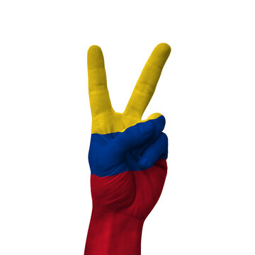 Hand making victory sign, colombia painted with flag as symbol of victory, win, success - isolated on white background