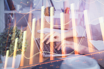 Double exposure of woman hands typing on computer and forex chart hologram drawing. Stock market...