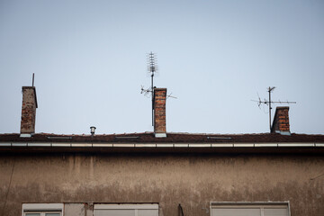 Fototapeta premium Television antennas, VHF and UHF frequencies, at the top of a European roof. VHF and UHF are two of the main TV transmission and reception systems.