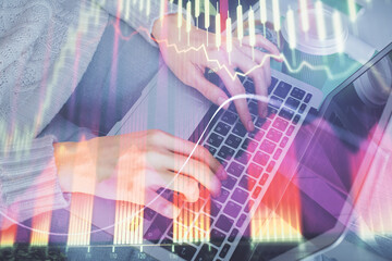 Double exposure of woman hands typing on computer and forex chart hologram drawing. Stock market invest concept.