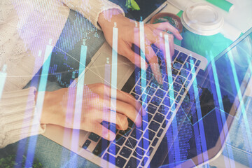 Double exposure of woman hands typing on computer and forex chart hologram drawing. Stock market invest concept.