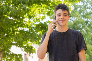 Fototapeta premium male teenager with mobile phone on the street