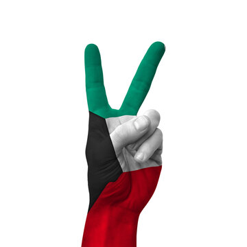 Hand making victory sign, kuwait painted with flag as symbol of victory, win, success - isolated on white background