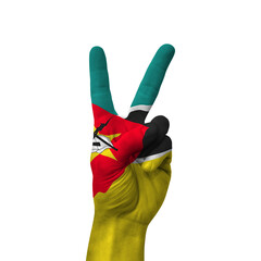 Hand making victory sign, mozambique painted with flag as symbol of victory, win, success - isolated on white background