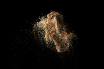 Gold sand explosion isolated on black background. 