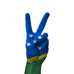 Hand making victory sign, solomon islands painted with flag as symbol of victory, win, success -...