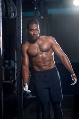 Fototapeta na wymiar Black male muscular shirtless man with abs and chalk on his hands