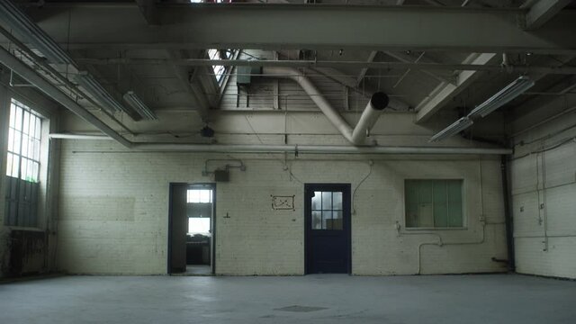 Large empty vacant industrial warehouse studio space. Background, industrial, 4K