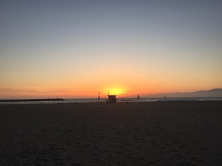 Landscape view of sandy beach sunset with distant coastline at sunset