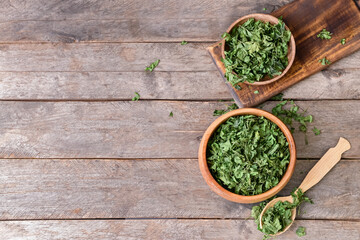 Dry parsley on wooden background