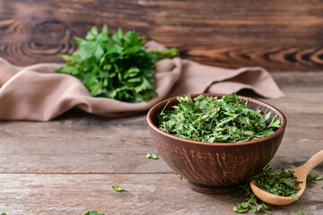 Bowl with dry parsley on table
